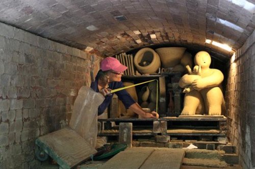 Joy Brown works on loading her work in the rear-most chamber.